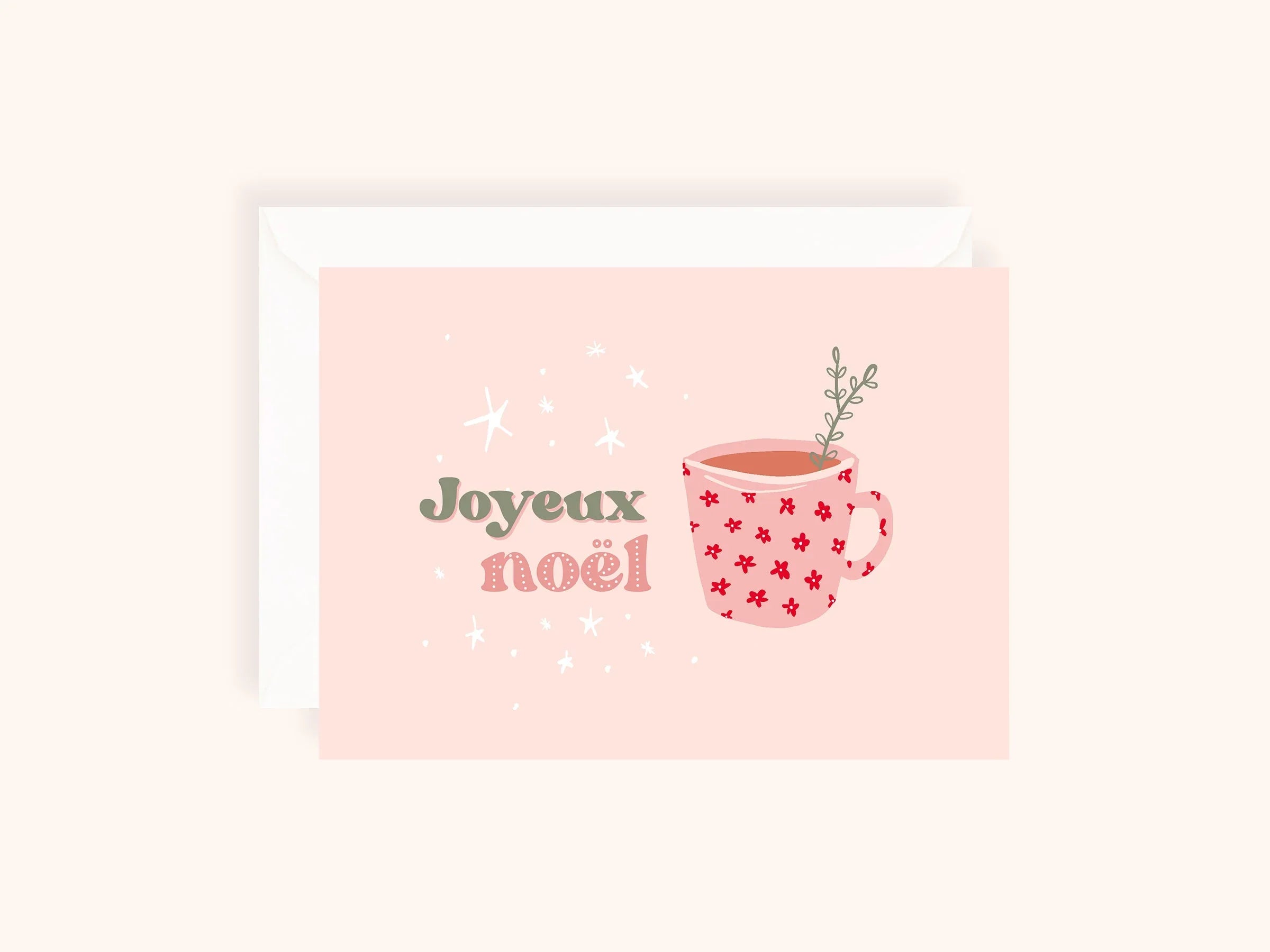 Carte de Noël rose avec tasse à motifs rouges et texte Joyeux Noël en vert et rose