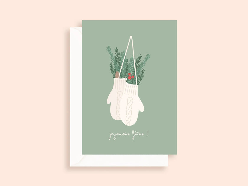 Carte de vœux minimaliste avec moufles blanches suspendues et décorations vertes, joyeuses fêtes