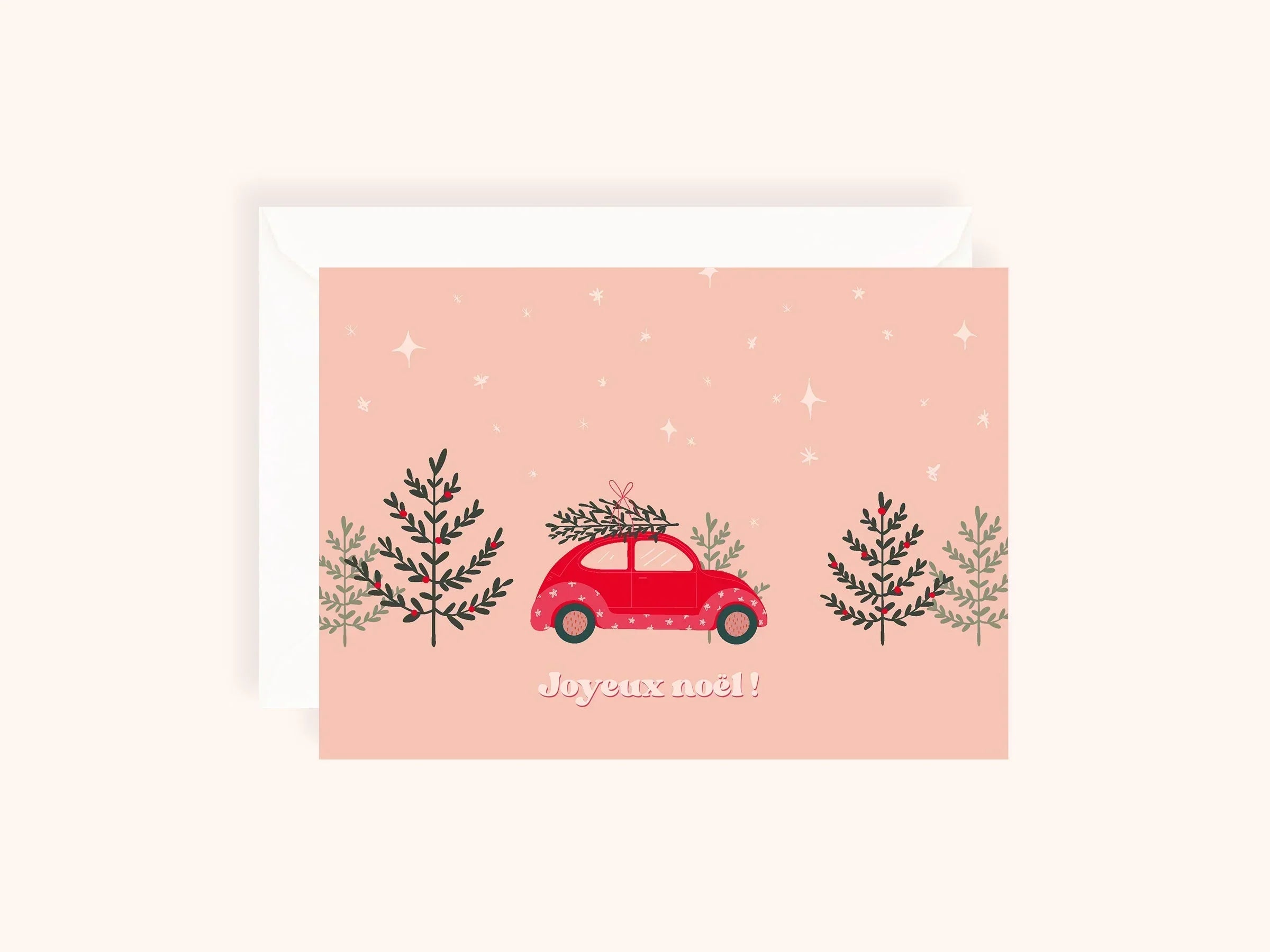 Carte de Noël rose avec voiture rouge portant un sapin sur le toit et texte Joyeux Noël