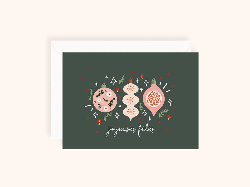 Carte de voeux avec décorations de Noël roses et vert foncé et inscription joyeuses fêtes