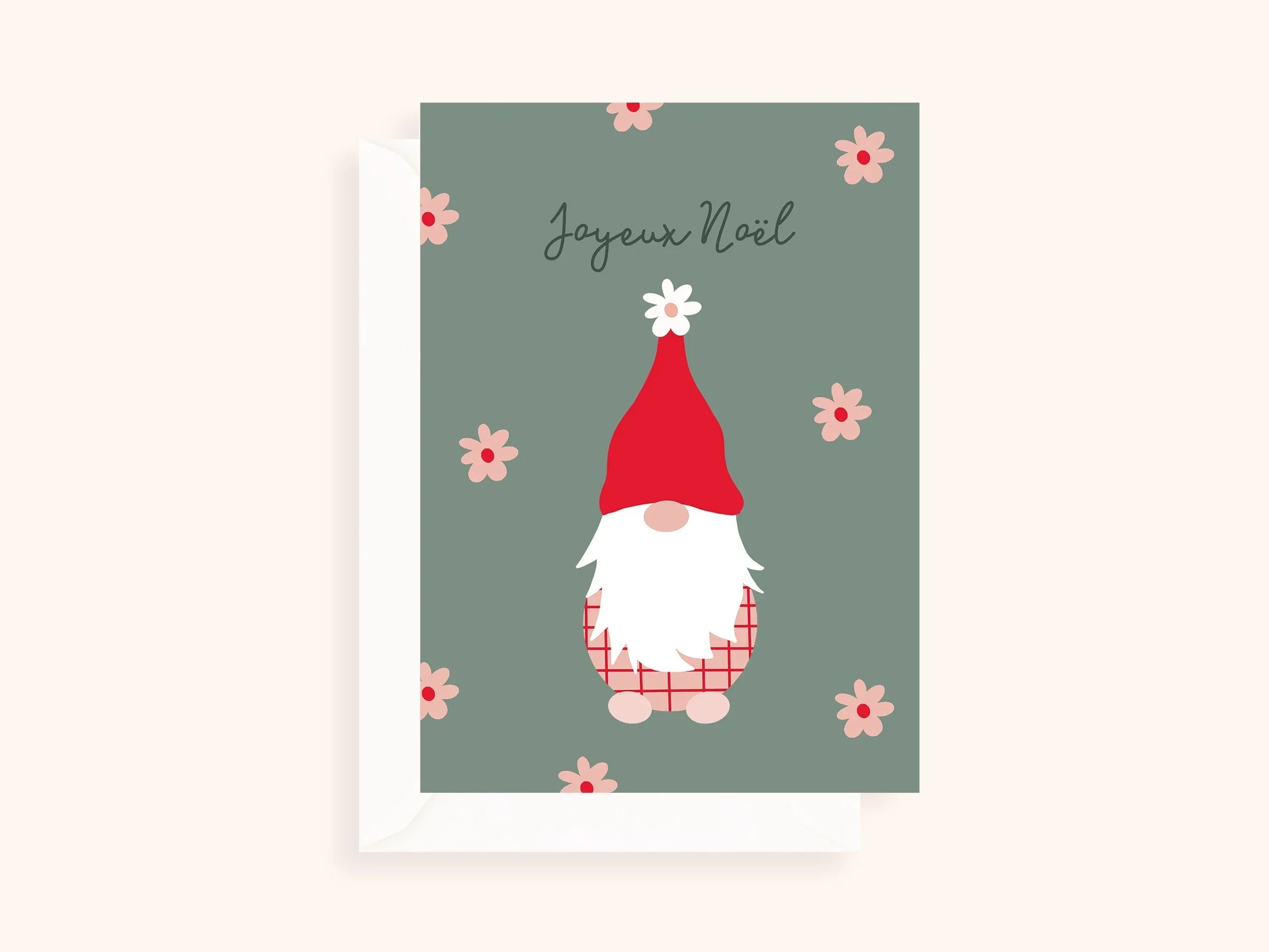 Carte de Noël avec un lutin au bonnet rouge, fond vert et fleurs roses, texte Joyeux Noël