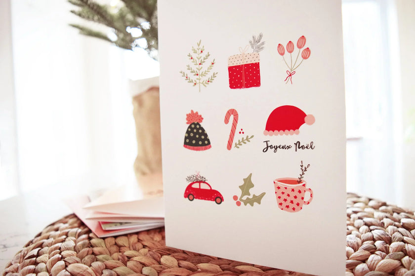 Carte de Noël décorée d'illustrations festives rouges et vertes, avec texte Joyeux Noël